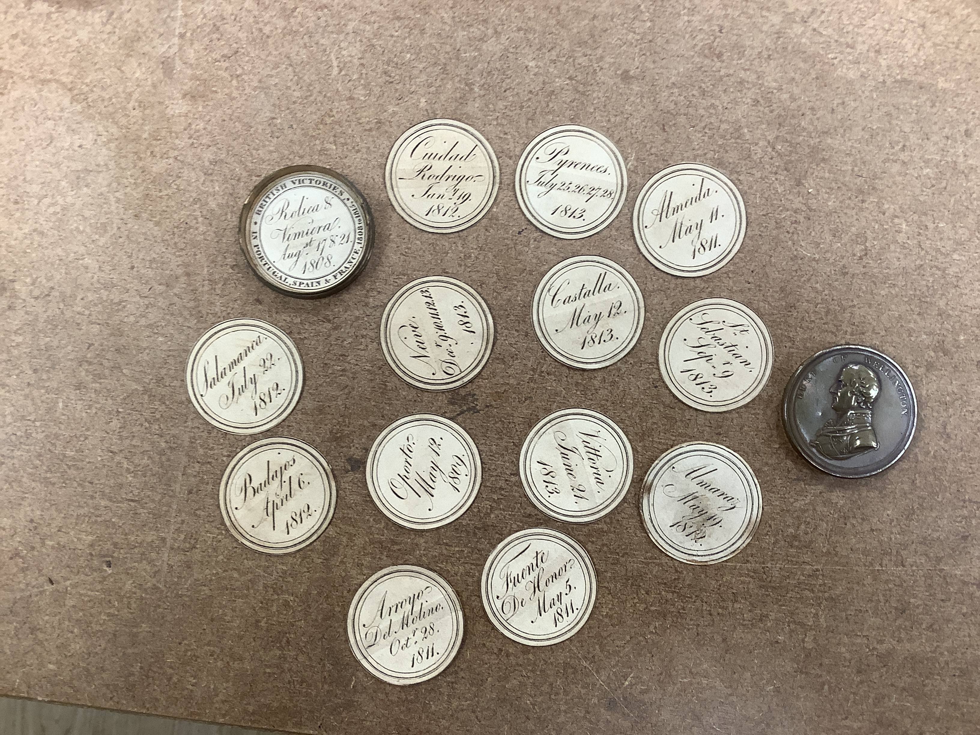An early 19th century AE cylindrical box formed in the shape of a coin commemorating The Duke of Wellington's British Victories in Portugal, Spain and France, 1808-1815, 4.7cm